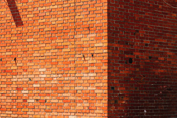 Old brick wall with cracks and damage