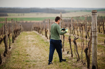 Portrait of man working on vineyard.