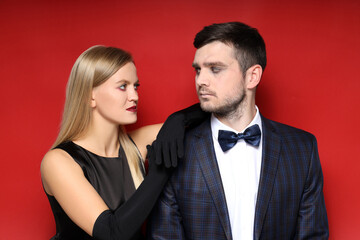Concept of Halloween, young man and woman on red background