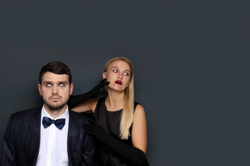 Concept of Halloween, young man and woman on dark background