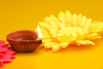 Concept of indian festival diwali. Traditional oil lamps on yellow background.
