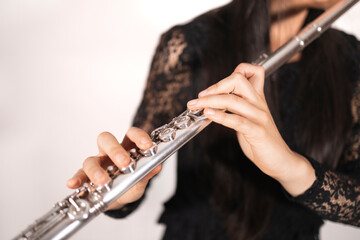 Close up of the hands of a female flutist while playing