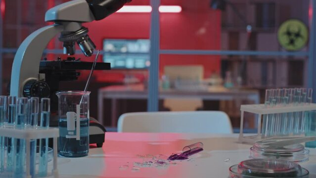 Tracking Right Of Broken Test Tube On Desk In Laboratory, Hazardous Outbreak Alarm With Red Flashing Lights Going Off