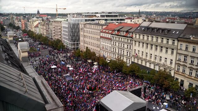 Wenceslas square in Prague full of protesting people with czech flags.