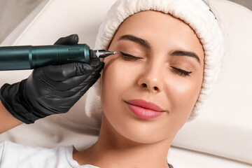 Young woman undergoing procedure of permanent eyeliner makeup, closeup