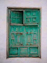 Old green door with several movable elements