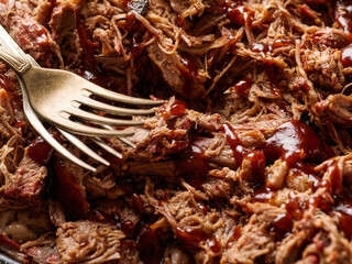 Traditional barbecue pulled pork. Slow cooked pulled pork shoulder. Juicy pork meat cooked in a smoker by low and slow