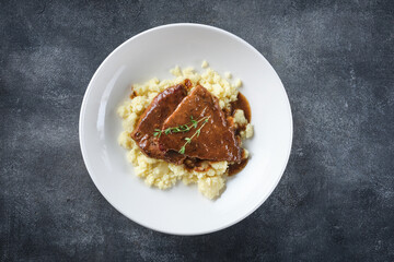 Roast beef smothered in demi-glace gravy with mashed potatoes.