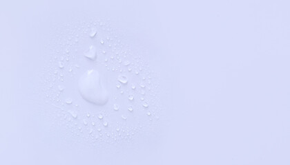 water drops of transparent gel serum on a pastel background