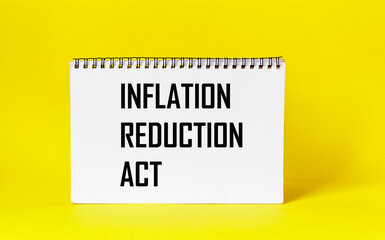 Business concept. On a yellow background, a notepad with the text Inflation Reduction Act