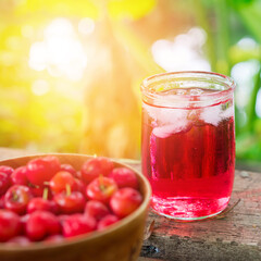 Glass of sour cherry juice with fresh red cherries, Cherry juice, on wood background, red drink, High vitamin C and antioxidant fruits.