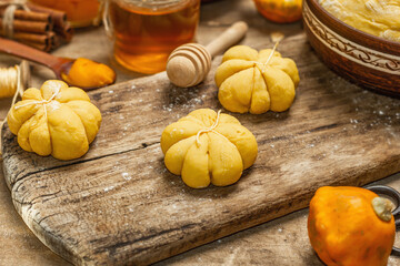 Pumpkin buns or biscuits, traditional fall baked goods. Seasonal ingredients for cooking food