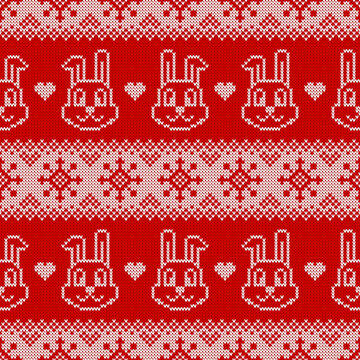 Knitted seamless pattern for 2023 new year of the rabbit. Vector background with cute bunnies, snowflakes and scandinavian ornaments. Red and white sweater print.