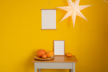 A mockup frame in the interior of a room with a yellow wall.