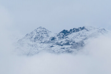 Fototapeta na wymiar Snow on the top of the Alps Innsbruck, surrounded by a cold sea of mist.