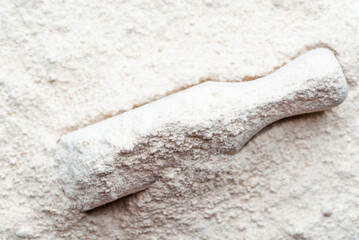 Baking background with flour in wooden scoop