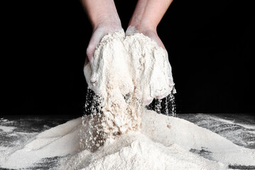 Baker with flour in hands. Preparing dough for bread. Baking concept.