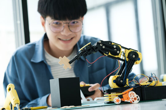 Technology Of Robotics Programing And STEM Education Concept. Science, Technology, Engineering And Mathematics Education. Asian Teenager Doing Robot Project In Science Classroom.