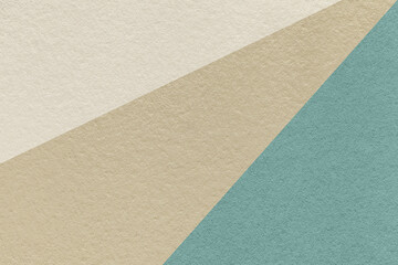Texture of old craft beige, blue and ivory color paper background, macro. Vintage abstract cerulean cardboard.