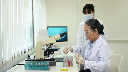 Senior biotechnology scientist conducting experiment in a laboratory. Concepts of science researching