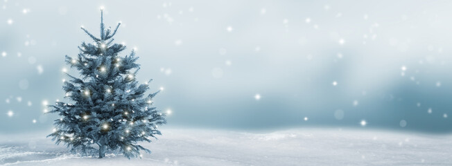 lighted isolated christmas tree in idyllic white snowy landscape, greeting card banner concept with...