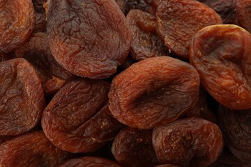 Tasty dried apricots as background, top view