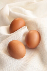 The three eggs on the white cloth background