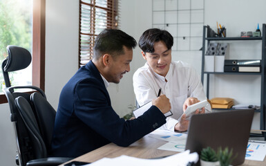 Asian business adviser meeting to analyze and discuss the situation on the financial report in the...