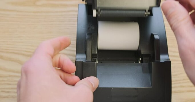 Receipt printer, checking the presence of thermal paper in the device. First-person view. Open the printer cover, look at the remaining paper roll.