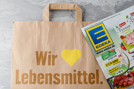 Edeka supermarket brochure and paper shopping bag with sign "Wir Lieben Lebensmittel" ( eng. We love food products)