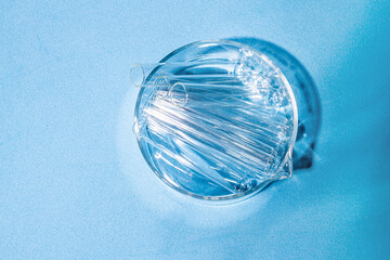 Laboratory equipment with advertising backgrounds. Medical flasks, bowls. Chemical laboratory research of cosmetics. Serums for the face.