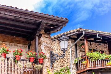 Picturesque stone houses with flowers and narrow streets in one of the most beautiful villages in Spain, Bárcena Mayor, Cantabria.