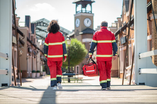 Paramedical staff in red uniforms going ahead