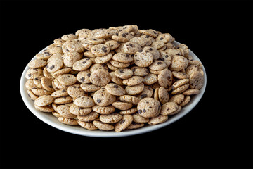 A full plate of round shaped chocolate flavored flakes