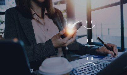 Satisfaction and Customer service concept ,Business people are touching the virtual screen on the happy Smiley face icon to give satisfaction in service. rating very impressed.
