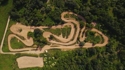 Aerial above view of a rural landscape with a curvy dirt road like a labyrinth running through it near Warsaw, Poland. High quality photo