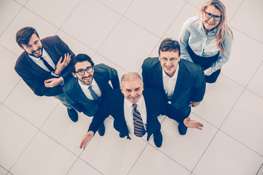 Top View. A Group Of Happy Business People Looking At The Camera.