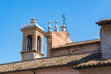 Fototapeta na wymiar Ornaments on a roof of a house on Via dei Cerchi in Rome, Italy