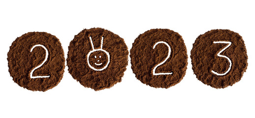 New year 2023 from coffee drawn on a white background from ground coffee, year of the rabbit