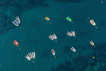 Aerial view to many rubber boats in the clear blue sea - 535200984