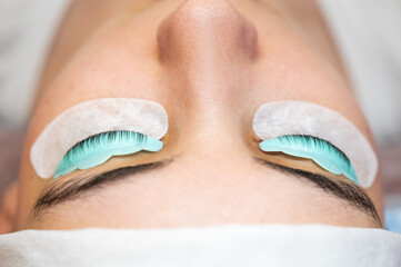 Profile of a woman in a beauty salon on the procedure of eyelash lamination. 
