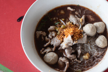 Thick noodles in a white bowl