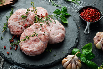 Caul-Fat Meatballs raw burger cutlet handmade. On a stone board. On a black background. Top view.