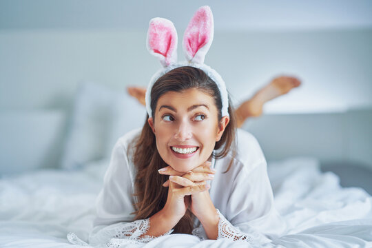 Nice and sexy brunette on bed with bunny ears