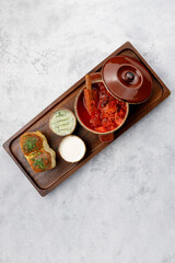 Ukrainian borscht with sour cream on a wooden board