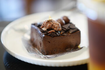 Piece of Bakery butter Cake Cream ferrero chocolate Flavor on white dish.