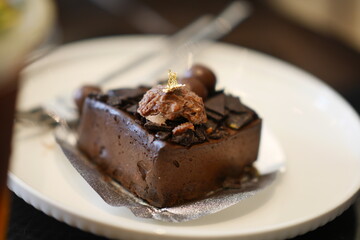 Piece of Bakery butter Cake Cream ferrero chocolate Flavor on white dish.