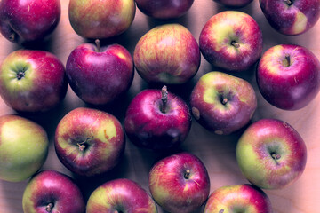 Concept for an simple autumn background. Close-up of fresh, organic apples on a wooden table. Flat lay, top view.