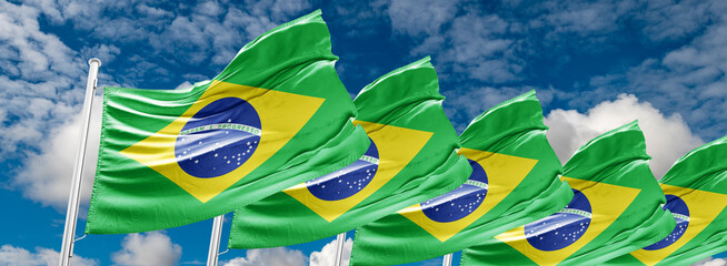 The flag of Brazil flutters in the wind in the center of the flag with the words order and progress Brazil election: ex-president Luiz Inácio Lula da Silva to face Jair Bolsonaro in runoff - obrazy, fototapety, plakaty