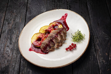 grilled meat with vegetables and spices on a black background
